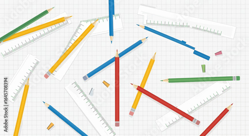 Artistic arrangement of colored pencils and rulers on a gridded background, perfect for creative projects and educational settings.
