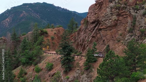 Offroad vehicle driving mountain landscape with trees in Colorado