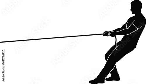 Silhouette of a man pulling a rope in a tug-of-war competition, showcasing strength and determination