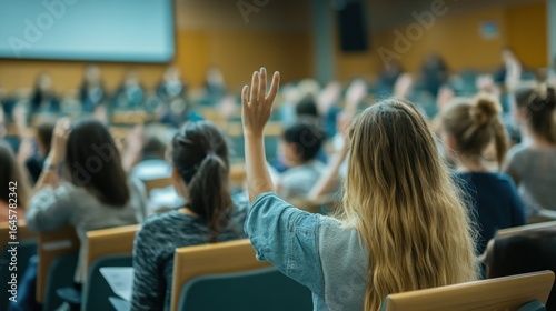 Students raising hands in a lecture hall