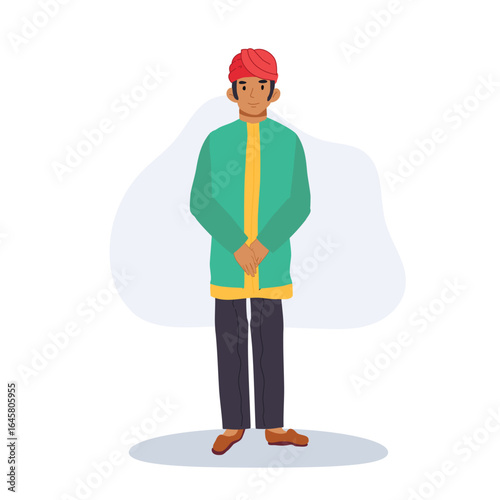 an indian man in a green kurta with yellow trim red turban and brown shoes wearing traditional attire