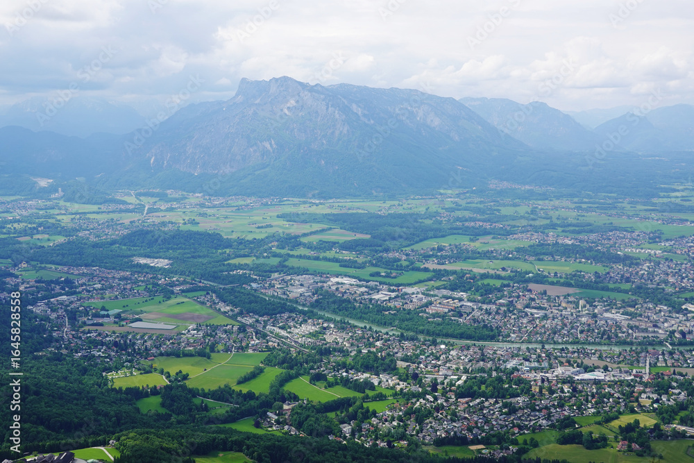 Fototapeta premium The panorama of Salzburg and the Untersberg mountain ridge from Gaisberg mountain, Austria