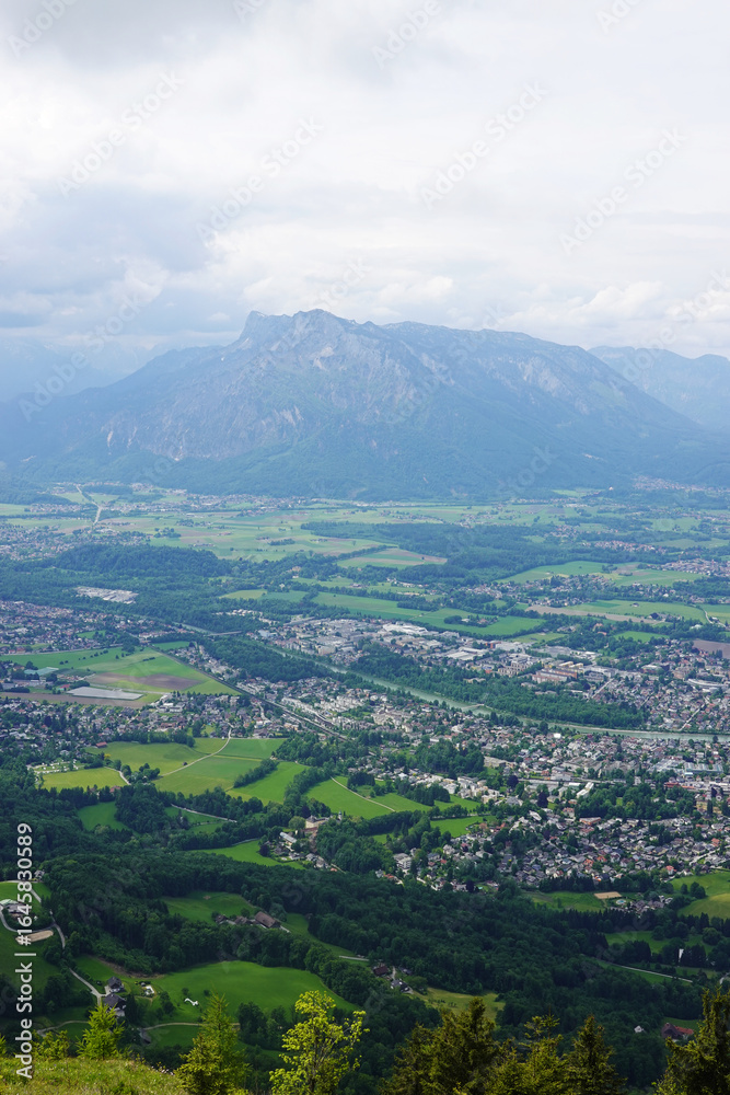 Fototapeta premium The panorama of Salzburg and the Untersberg mountain ridge from Gaisberg mountain, Austria
