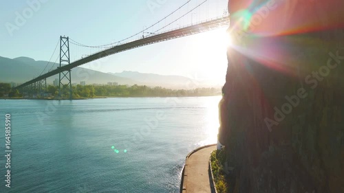 ascending aerial view of a bridge over a bay near Vancouver shore