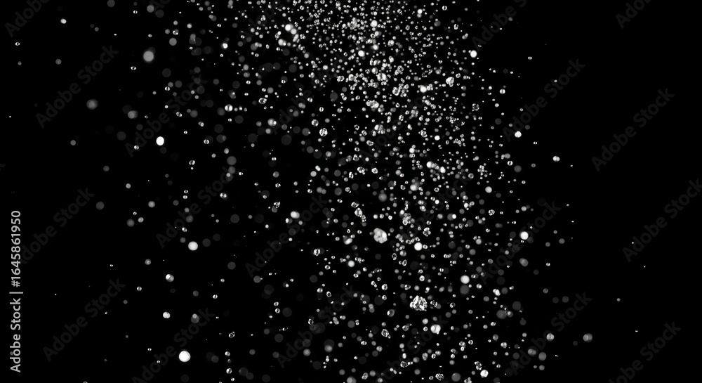 Sparkling water droplets falling against a dark background for abstract design elements Sparkling water droplets falling against a dark background for abstract design elements