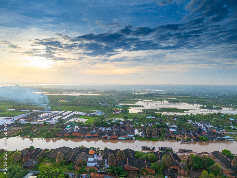 Naklejka premium Aerial view of Mang Thit brick kiln in Vinh Long. Burnt clay bricks used in traditional construction of Vietnamese. Mekong Delta, Vinh Long, Vietnam
