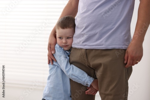 Photography Little boy clinging to his father indoors. Separation anxiety