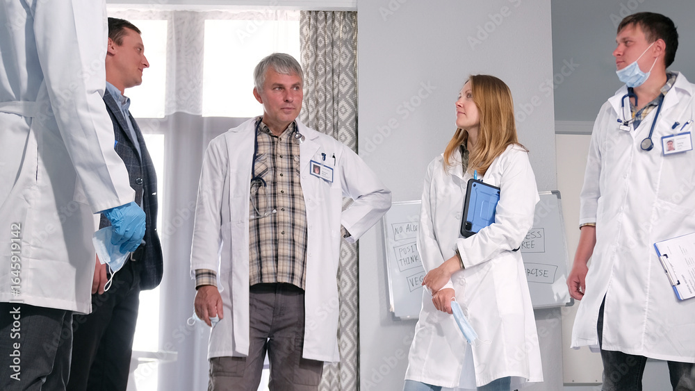 Αυτοκόλλητο A group of doctors discusses the patient's condition and upcoming heart surgery with a relative