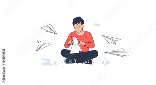 Boy creating paper airplanes surrounded by his creations of dreams and imagination expressed through the folded paper crafts spread around