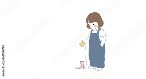 Charming child in overalls playfully tugs a tiny plush toy, evoking innocence and joy.