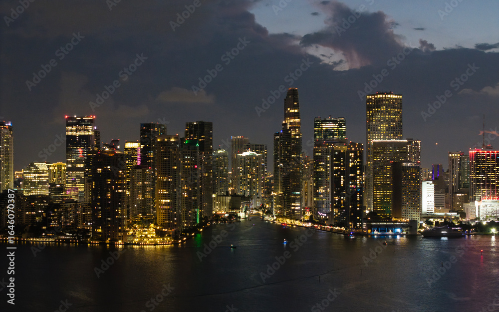 Fototapeta premium Aerial night view of Brickell skyline in downtown Miami. Skyscrapers above Miami. Scenic panorama of Brickell financial district. Brickell in Miami city. Brickell Urban landscape.