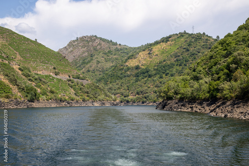 Boat tour through the Sil Canyon in Ribeira Sacra, Galicia, Spain, departing from Embarcadoiro da Ponte do Sil, Monforte de Lemos. Scenic river and vineyards.