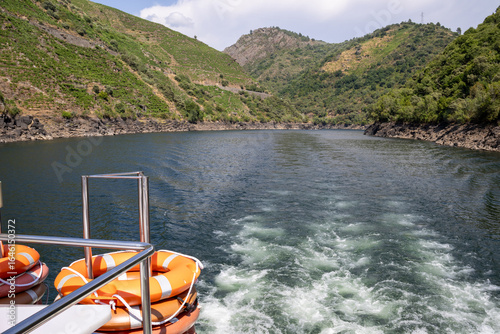 Boat tour through the Sil Canyon in Ribeira Sacra, Galicia, Spain, departing from Embarcadoiro da Ponte do Sil, Monforte de Lemos. Scenic river and vineyards.