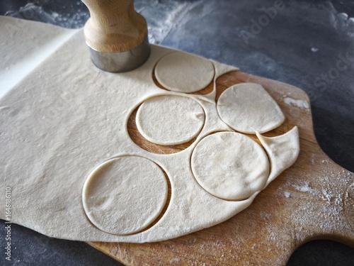 The process of making homemade pastries and dishes. Preparation of round shapes using a cut-out mold. For donuts, biscuits, ravioli, dumplings and other dough dishes