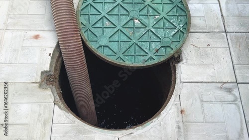 Pipe in the drainage pit. Pumping out sewage from a septic tank. Septic tank service