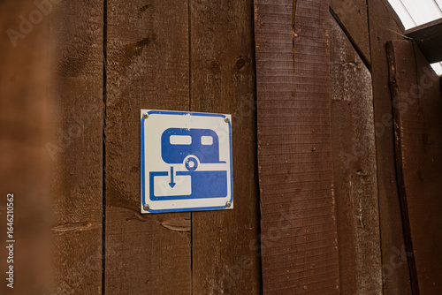 Camper waste disposal: Sign indicating a service point for caravans and motorhomes. Maintaining hygiene at an outdoor park facility