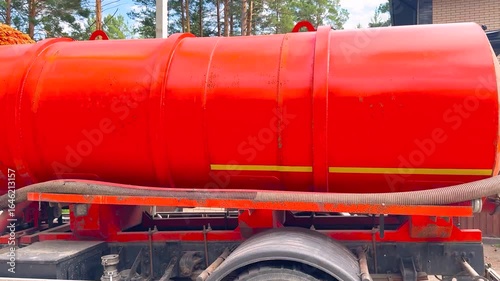 Sewage Tank truck. Red Septic truck. Sewer pumping machine. Pumping out sewage from a septic tank. Septic tank service