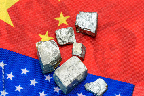 Metallic ore fragments - likely rare earth or strategic materials - laid atop overlapping Chinese and American flags. Shifting the balance in escalating China - U.S. trade and policy negotiations.