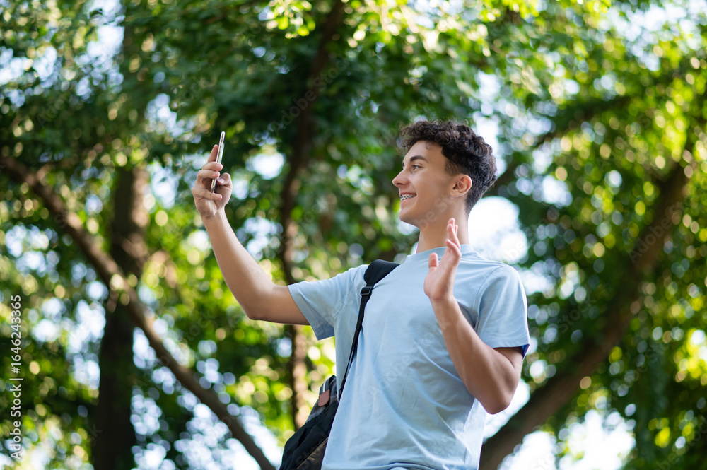 Sweet dark-haired teen with a phone in hands in the park Sweet dark-haired teen with a phone in hands in the park