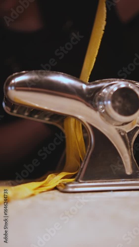 The process of cutting pasta in a noodle cutter