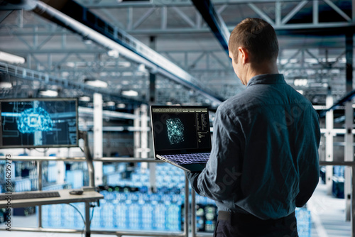 Wallpaper Mural Data center IT specialist monitoring AI LLM visualization output to verify inference patterns. Programmer analyzing neural language network structure in server room using laptop Torontodigital.ca