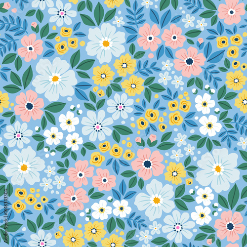 Seamless floral pattern with beautiful blue, yellow ,pink and white color flower blossom garden on blue background. Cute liberty hand drawn floral pattern for your fabric, summer background, textile 
