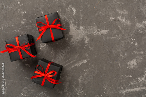Black gift boxes on wooden background, top view. Black Friday concept