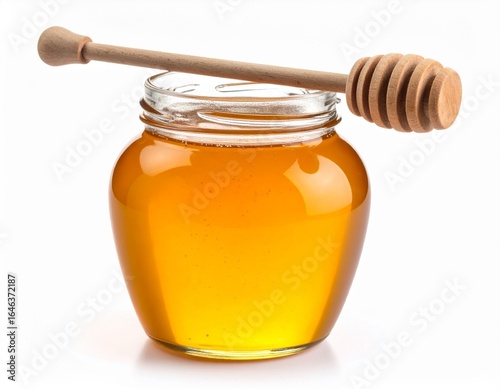 A jar of honey with wooden dipper, isolated on white background