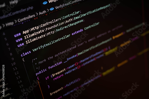 Obraz na płótnie Close-up of computer screen displaying PHP code for a web development project using Laravel framework, highlighting software engineering and back-end programming in modern tech.