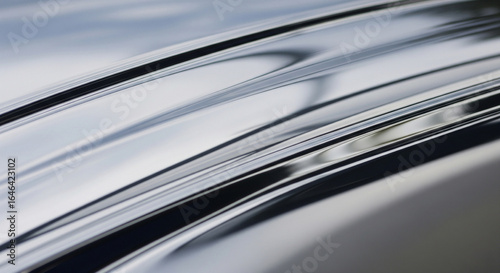 A high-quality close-up of polished chrome with a subtle reflection and a hint of a soft light source.