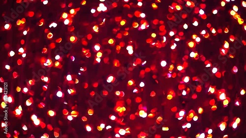 Vibrant red backdrop glimmering with shining, sparkling particles, generating festive visual energy radiating celebration and dynamic luminous excitement