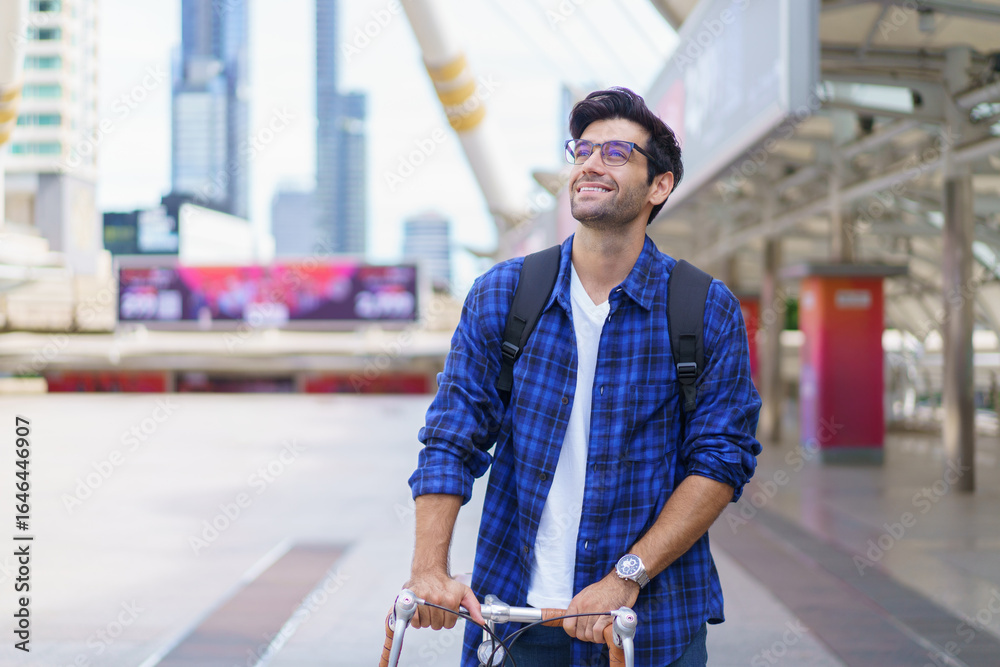 Asian man walking bicycle in city, commuting to work for fitness and eco-friendly lifestyle. Asian man walking bicycle in city, commuting to work for fitness and eco-friendly lifestyle.