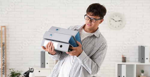 Stressed young man with fol...