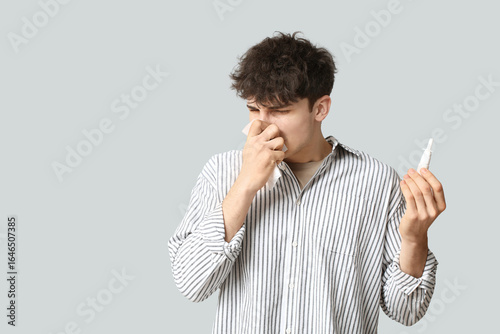 Young man with nasal drops ...