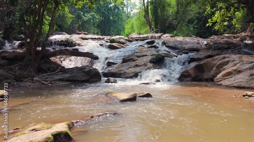 Beautiful waterfall in a tropical forest, Water stream flowing over rocks in a national park, The serene beauty of a jungle creek