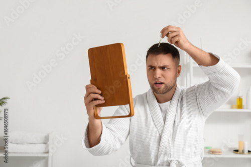 Young man with mirror using...
