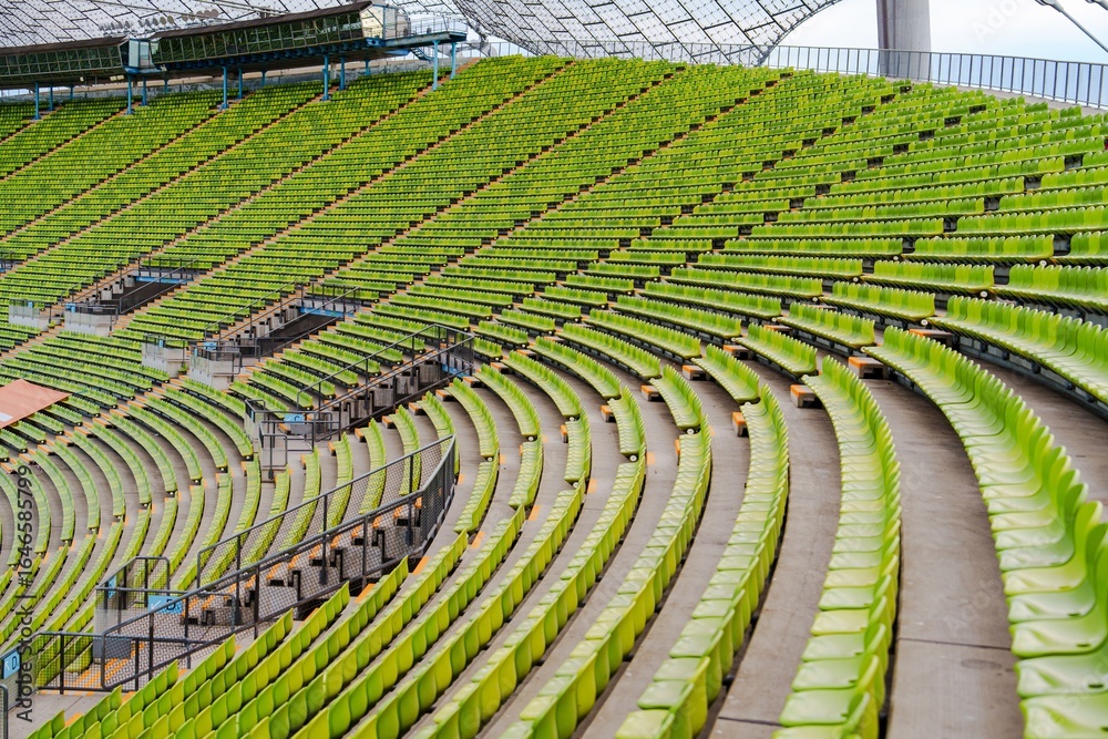 Fototapeta premium A large stadium featuring green seating, designed for sports events and concerts. Perfect for promotional materials and event planning concepts in entertainment venues.