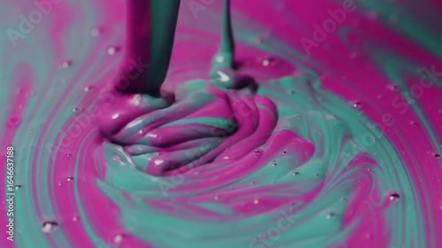Viscous pink & teal liquid flowing, creating swirling patterns