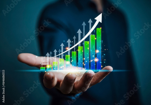 Hand holding a glowing bar graph showing financial growth and success