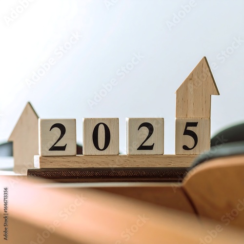 Wooden blocks spelling 2025, ascending arrow trend
