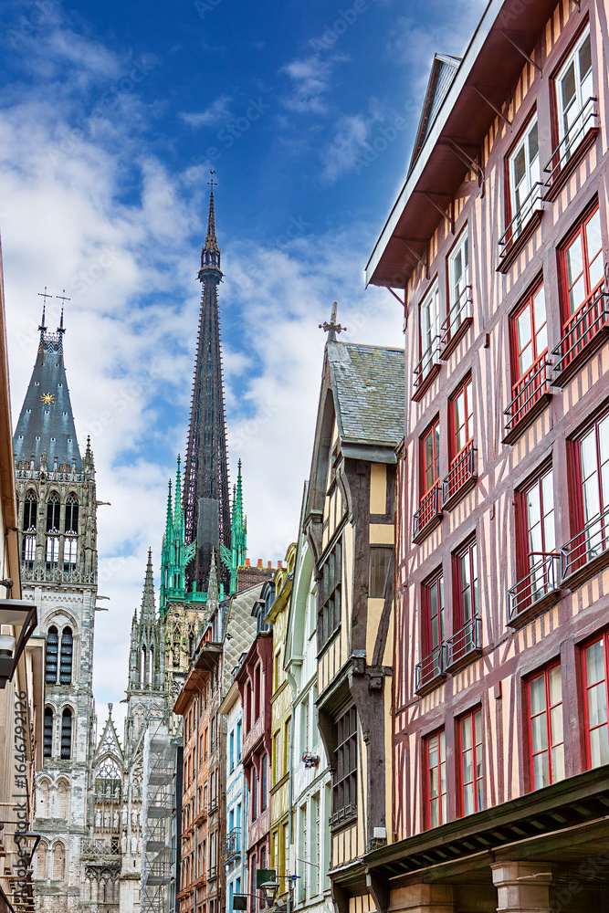 Obraz premium Medieval street lined with half-timbered houses near Rouen Cathedral in Rouen, France showcasing architectural beauty and vivid colors