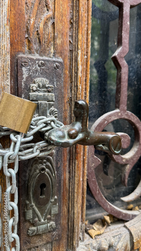 Wallpaper Mural Ancient door chain-locked against spirits, Victorian mystery vibes, Samhain reflections, rustic safety emblem, hidden stories linger Torontodigital.ca