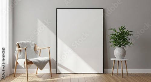 An interior scene showcases a blank canvas leaning against a wall, illuminated by natural light, with a chair and a potted plant adding elements of design and comfort.