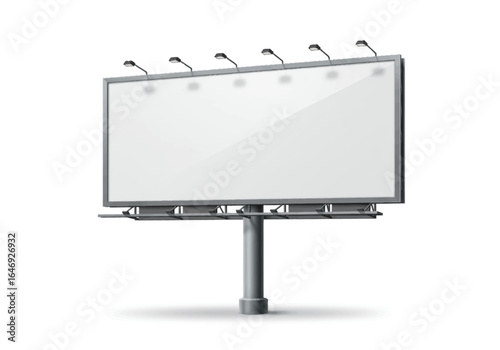 A large blank billboard with overhead lamps is mounted on a tall gray pole
