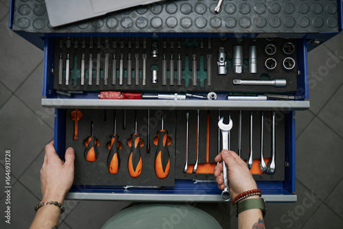 Open toolbox with organized tools in a workshop garage setting