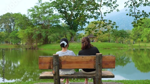 Tourists relaxing by taiping lake in perak, malaysia