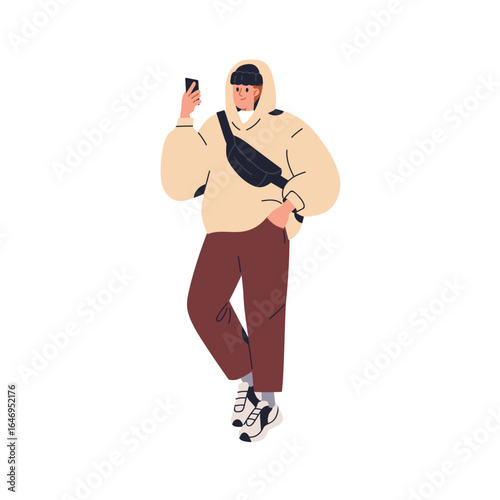 Man holding mobile phone in hand, walking on street. Young male looking at sm...