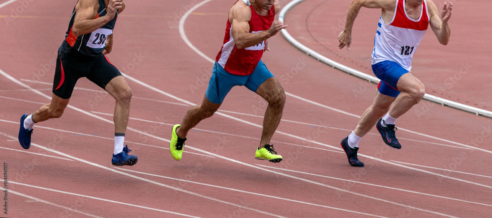 Fototapeta premium Group middle-aged athlete running sprint race during veterans athletics competition