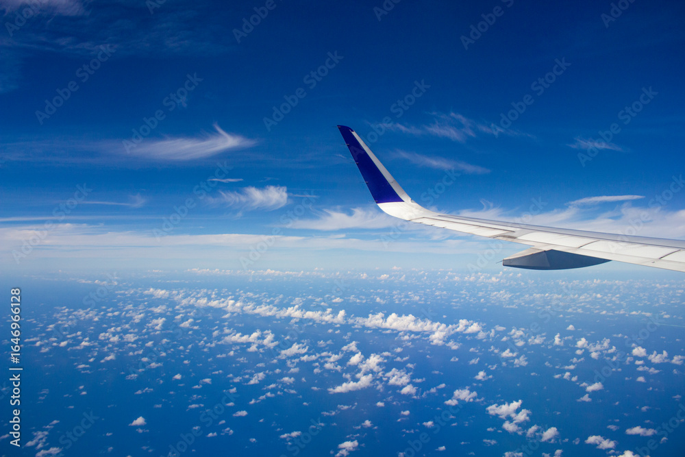 Obraz premium High Altitude View Of Airplane Wing And Cloudscape
