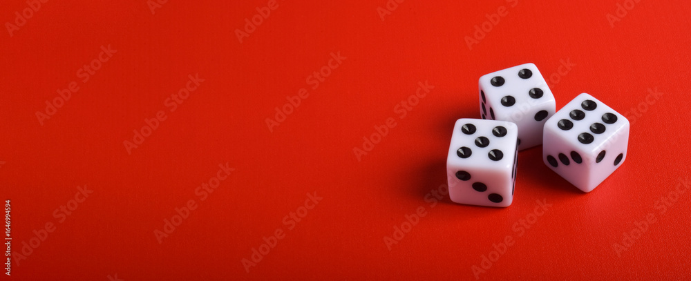 Three dices isolated on red background with copy space for text Three dices isolated on red background with copy space for text